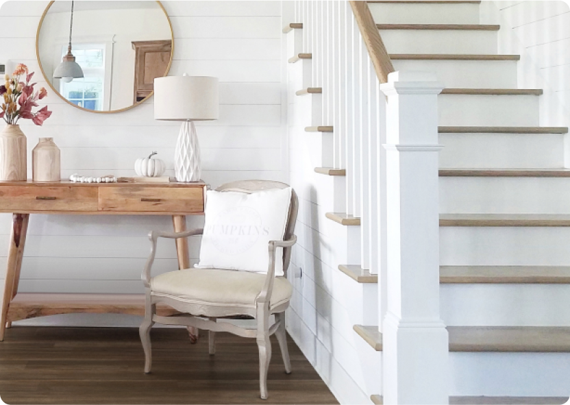 A white staircase with medium brown laminate wood-look stair treads.