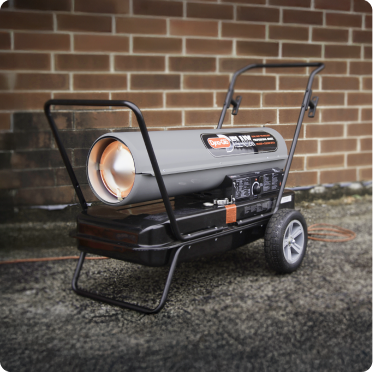 Long, narrow heater with handle and wheels in front of a brick wall.