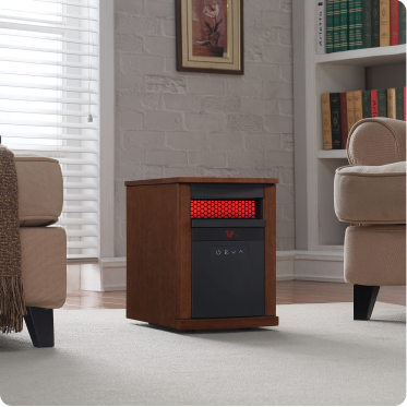 Rectangular electric heater between two arm chairs in a neutral living room.