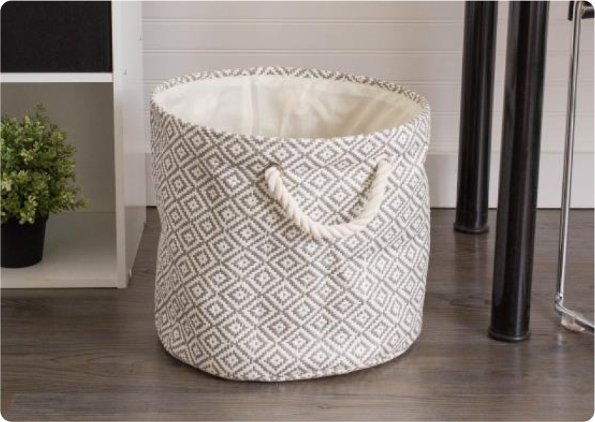 A gray and white patterned fabric circular bin.