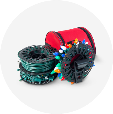 Two sets of Christmas lights wrapped around light storage reels and a red storage bag.