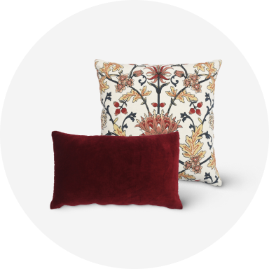 A blue decorative throw pillow and a white and black decorative throw pillow.