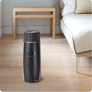 Small cylindrical heater in a minimalist bedroom on a light wood floor.